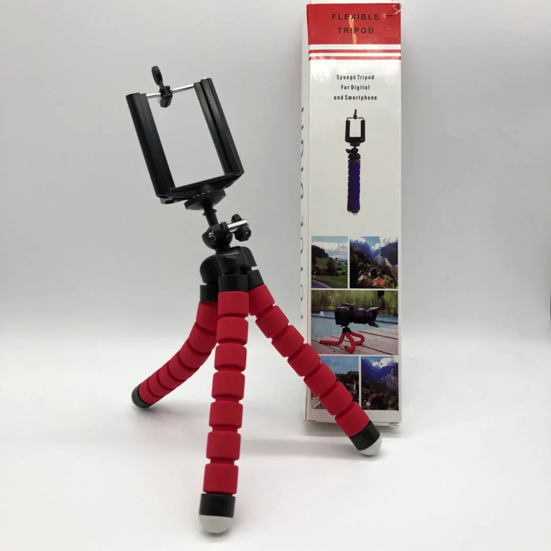 Flexible red and black smartphone tripod with adjustable legs and phone holder, product box in background