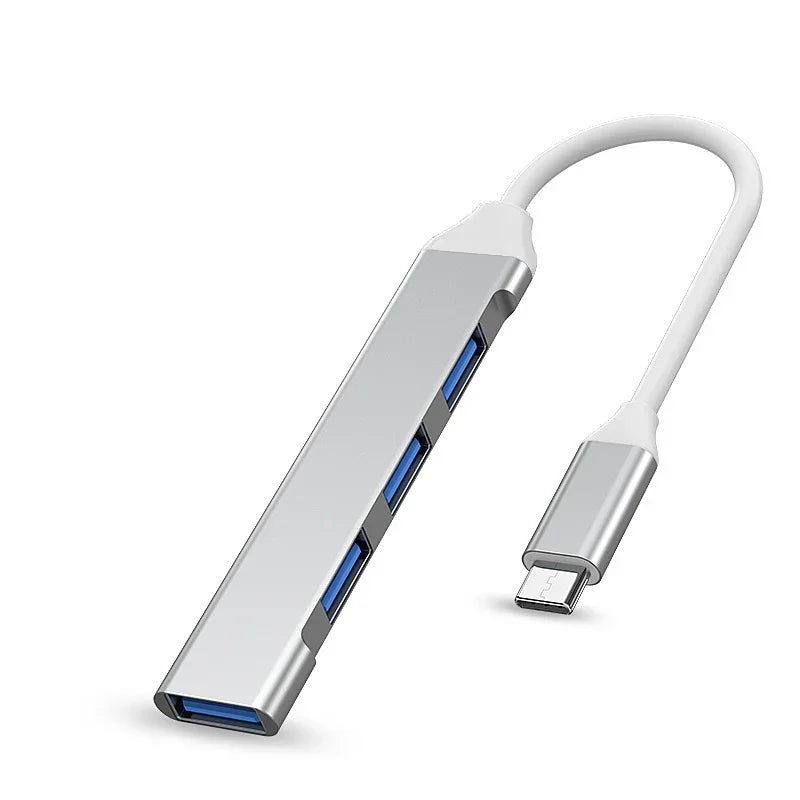 Silver USB-C hub with multiple USB 3.0 ports on white background