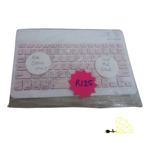 Pink wireless keyboard in packaging, price tag R125, labeled for demo only, not for sale